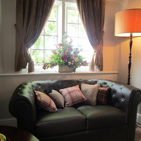 The Three Crowns Hotel Chagford Bagian luar foto A leather sofa